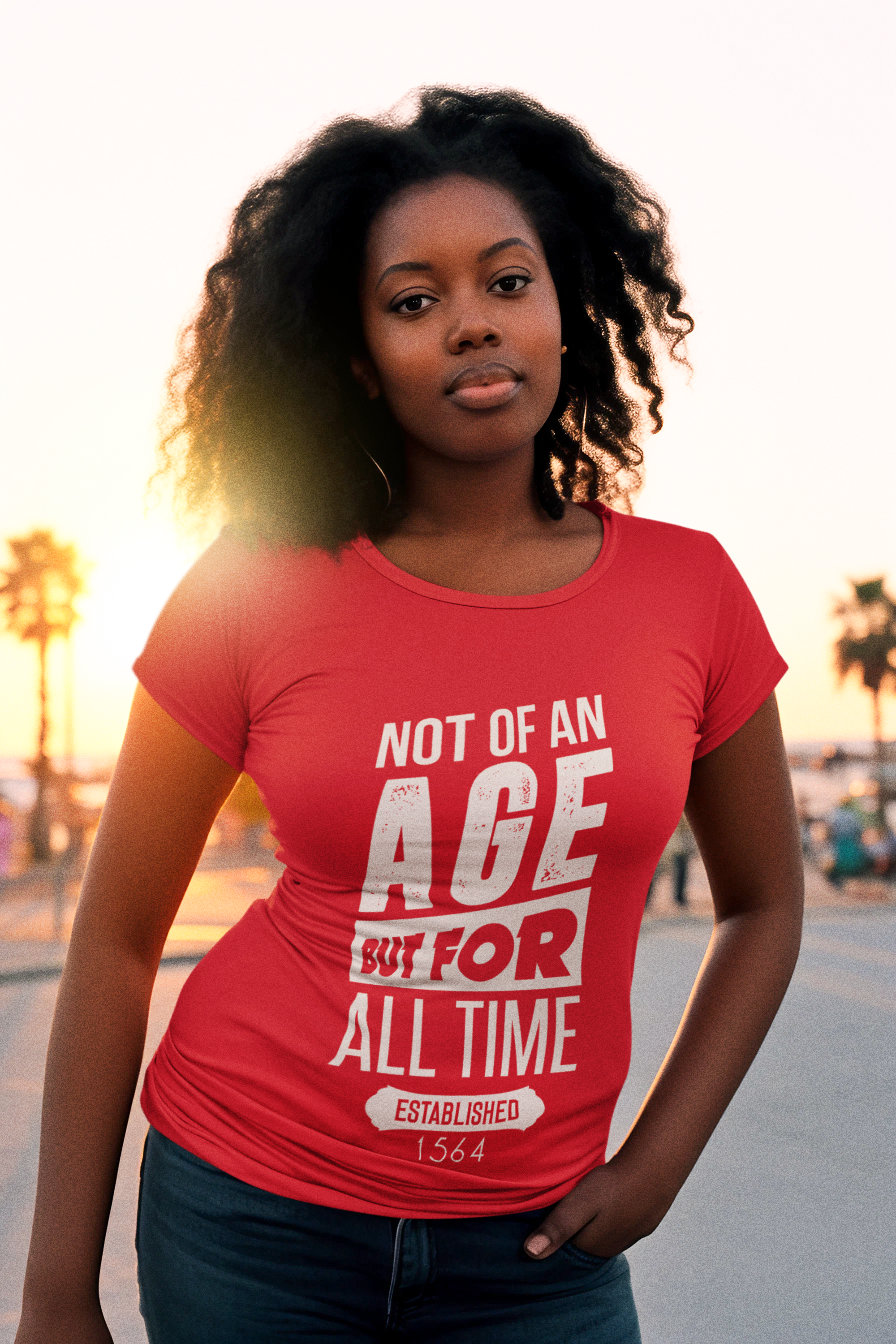 Curly hair woman in red Not Of An Age But For All Time t-shirt