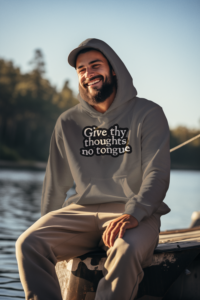 Bearded man with a had and a grey Give Thy Thoughts No Tongue hoodie